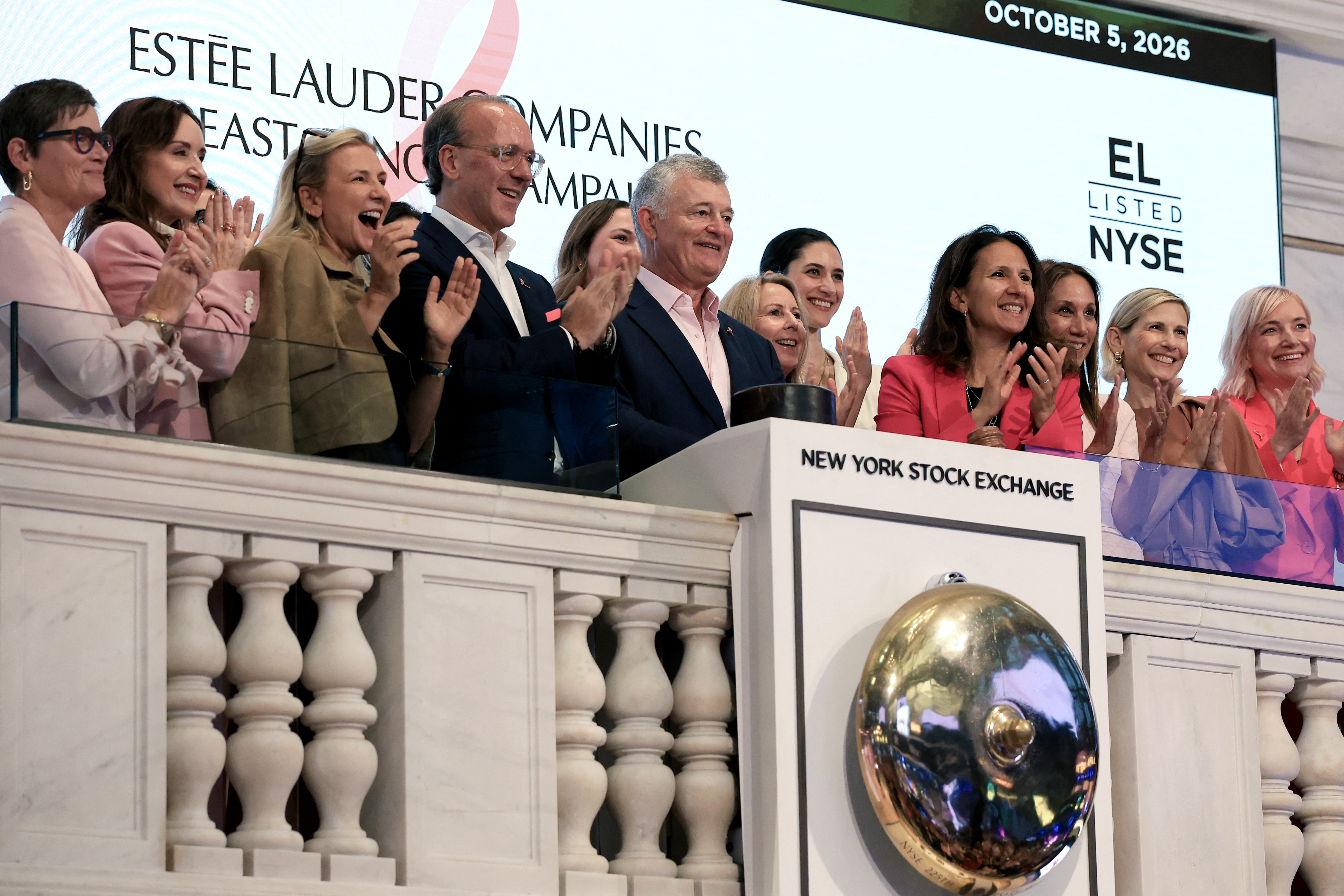 Executives from Estee Lauter ring the opening bell at the New York Stock Exchange.
