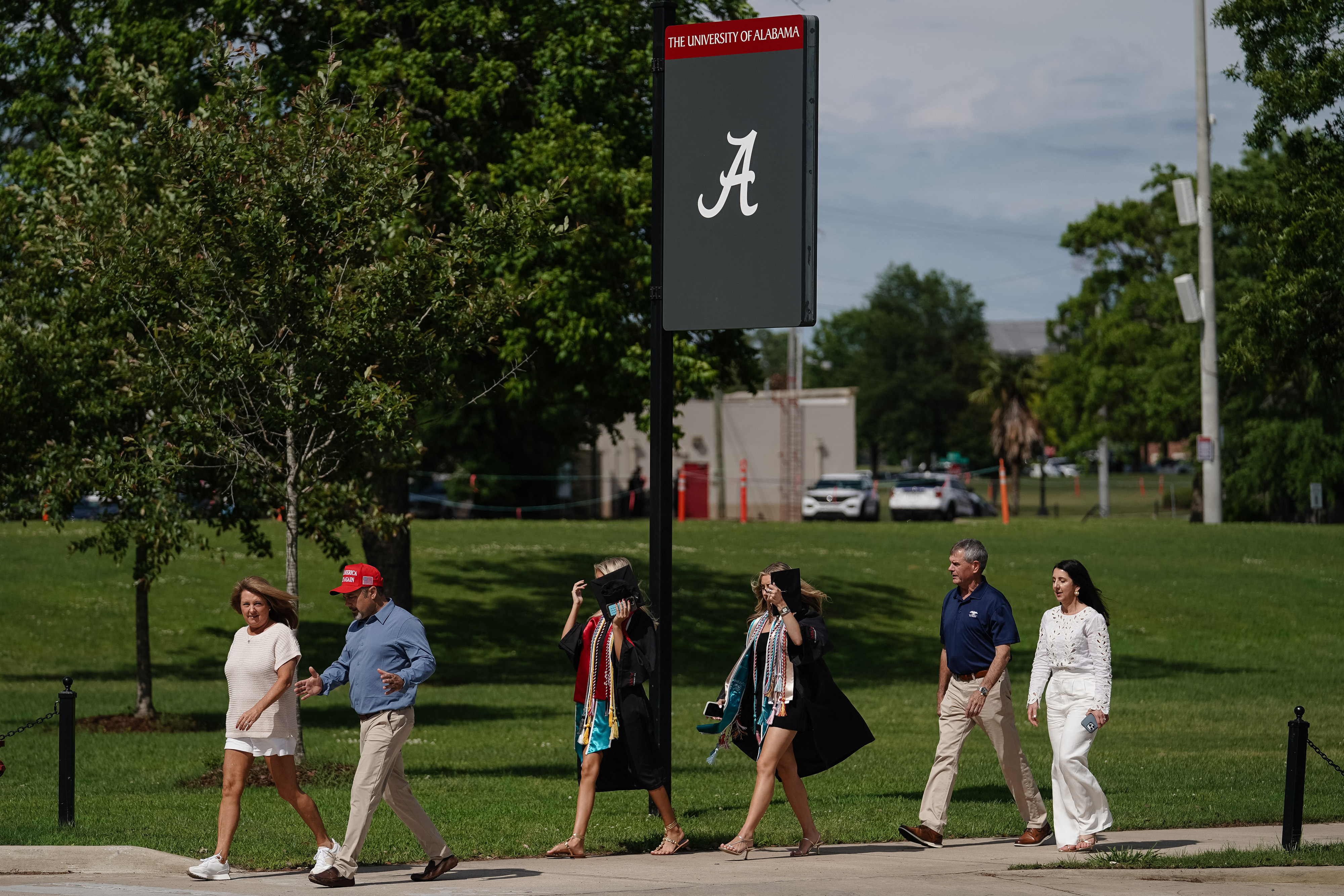 Graduates and their families walk around the University of Alabama campus.