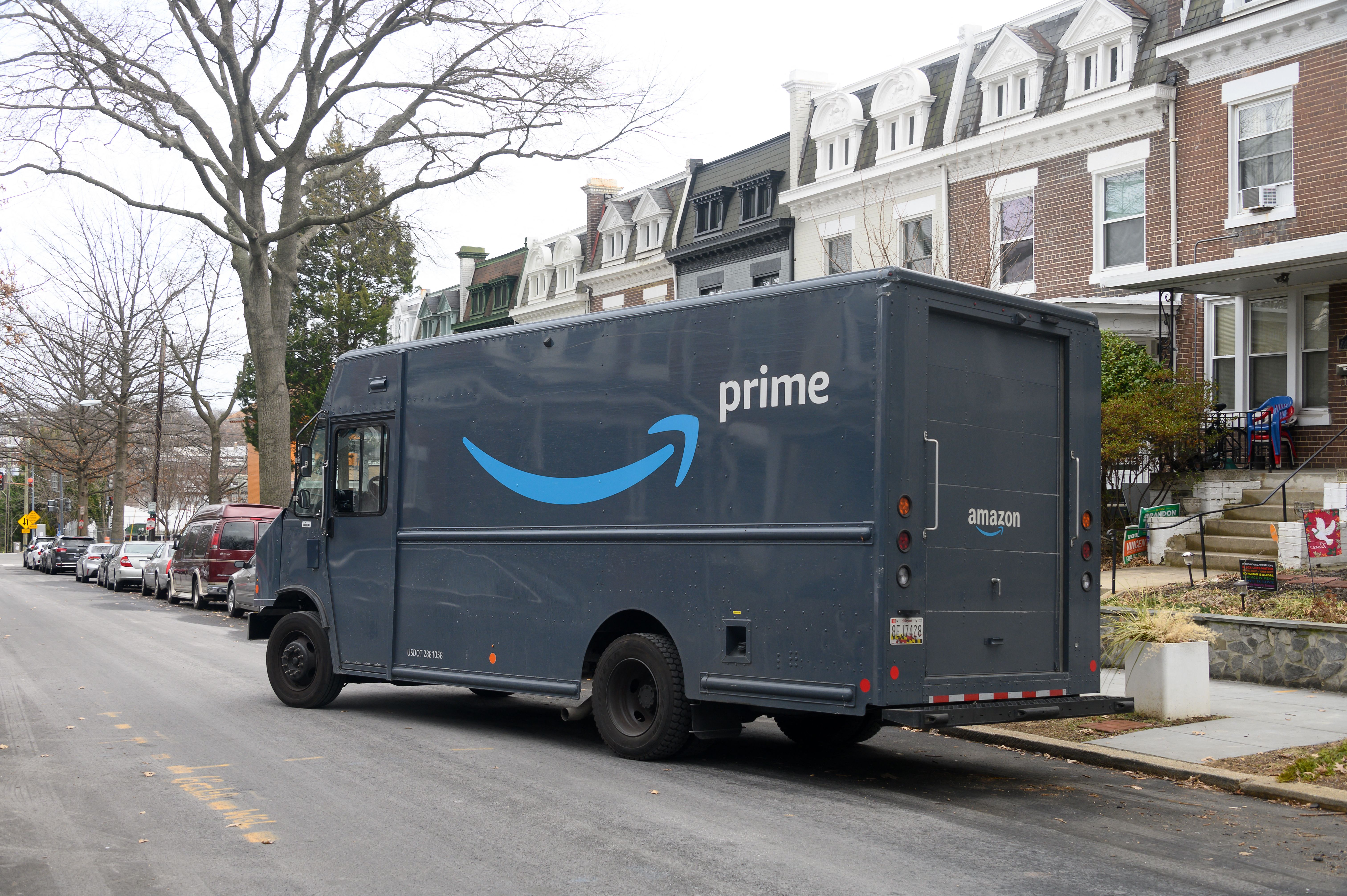 An Amazon truck parked on a residential street.