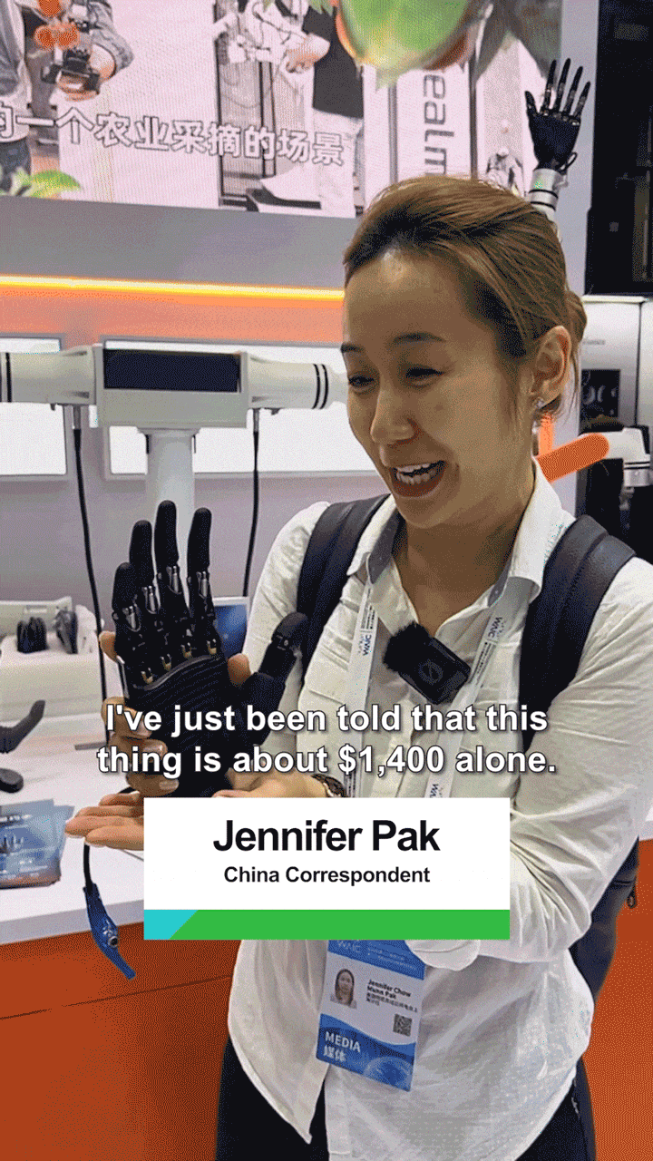 A gif from the linked video shows Marketplace reporter Jennifer Pak holding a robotic hand.