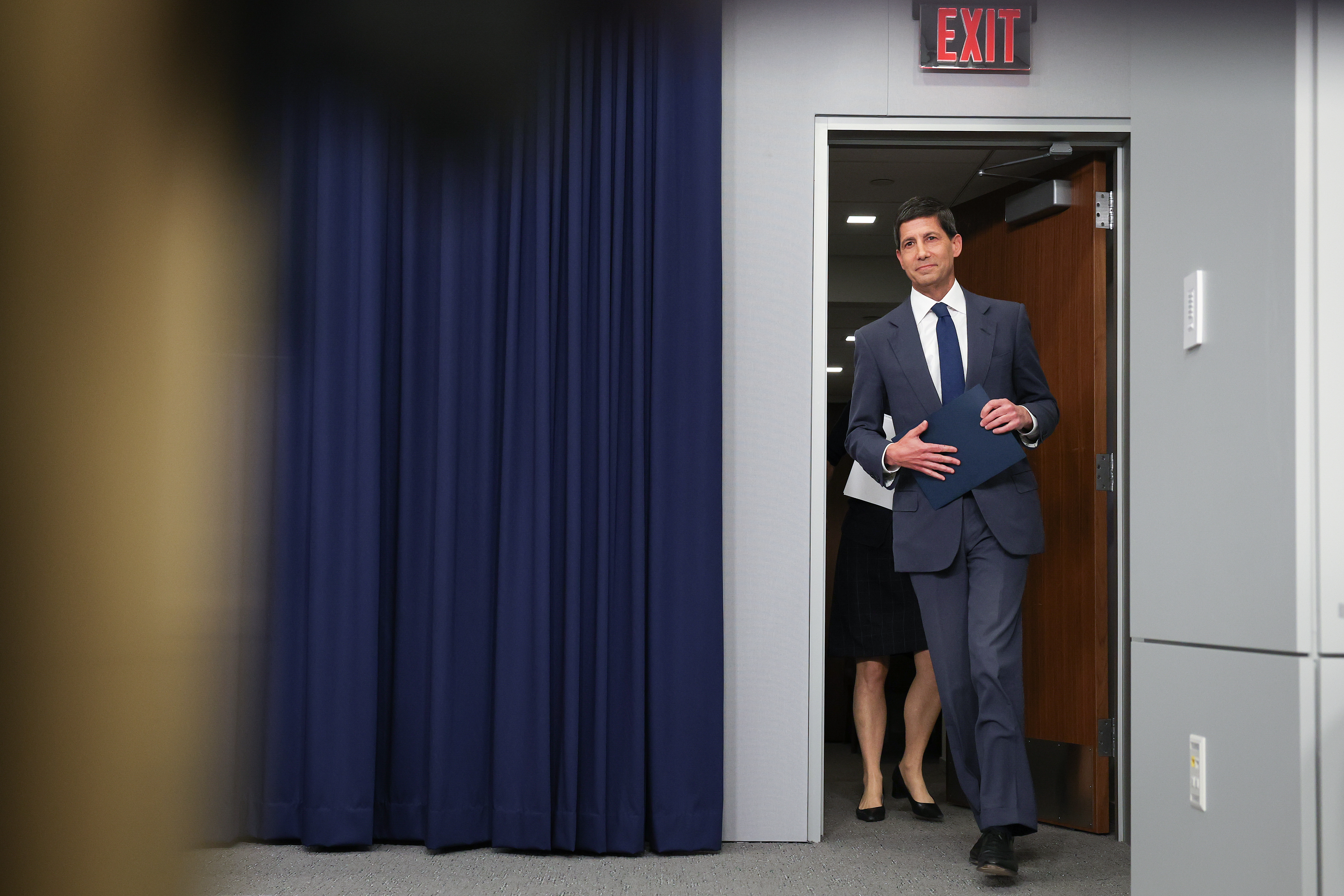 Kevin Warsh walks in a room.