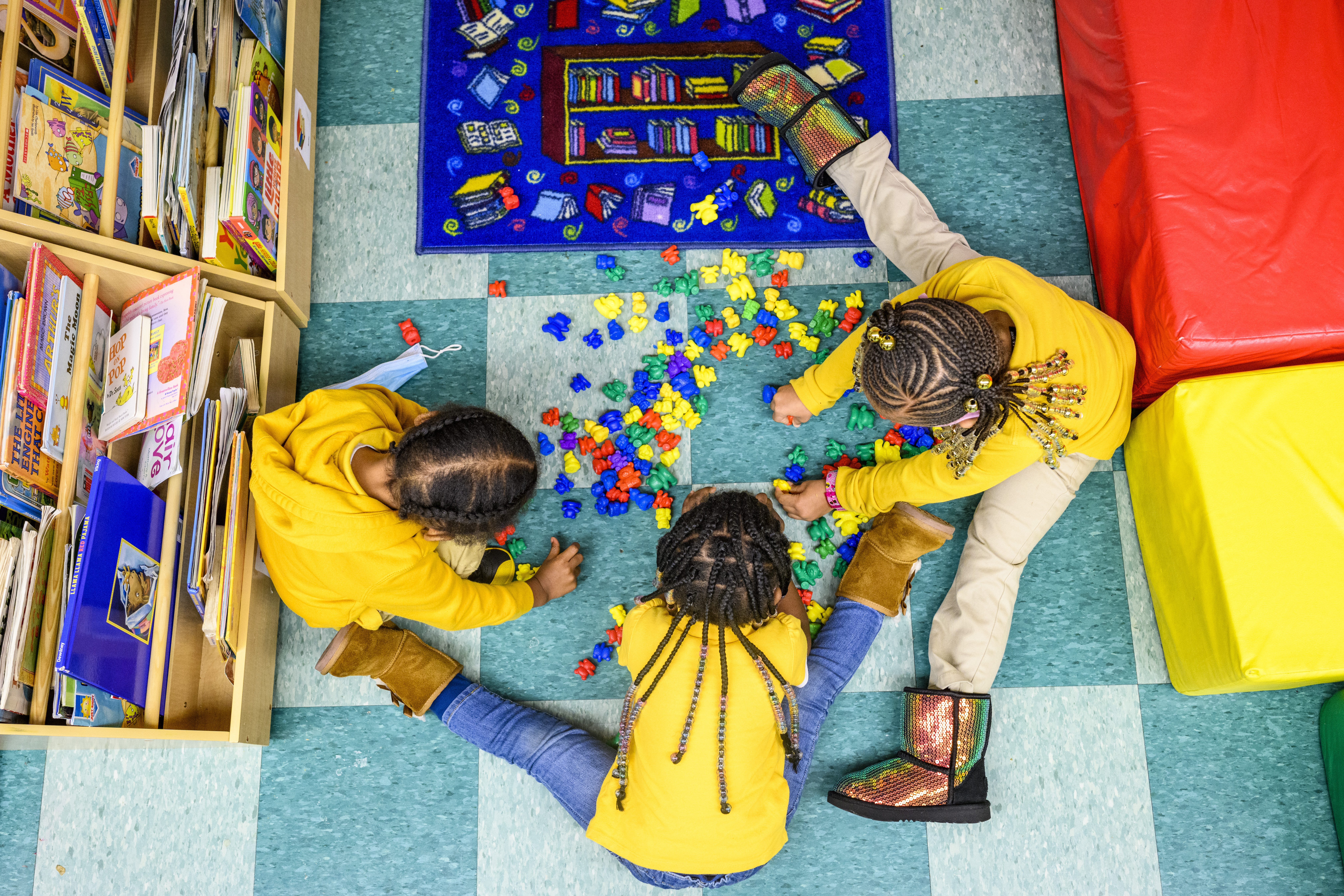 An overhead photo of children playing at a daycare center.