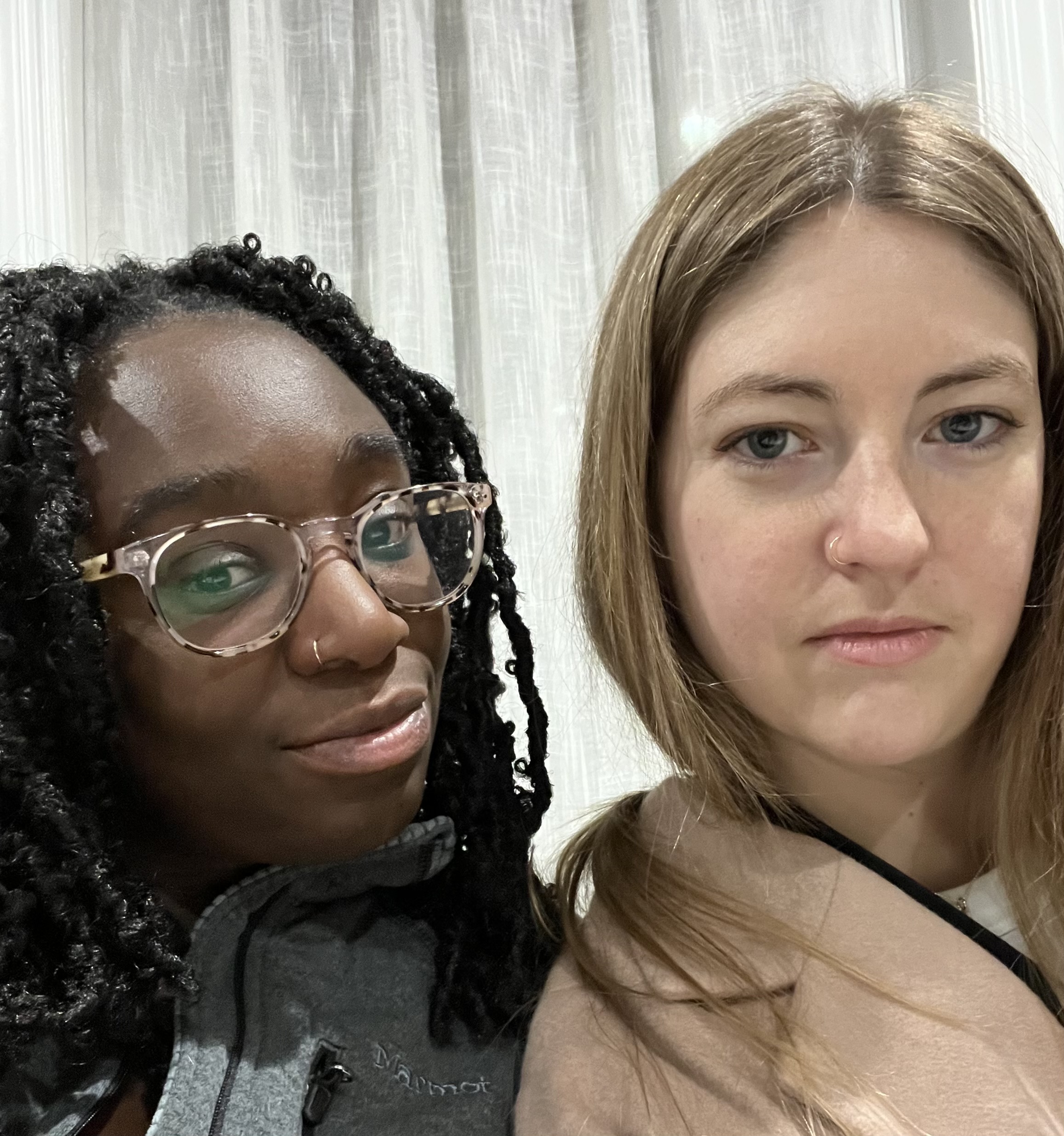 Two women pose for a selfie wearing fake nose rings.