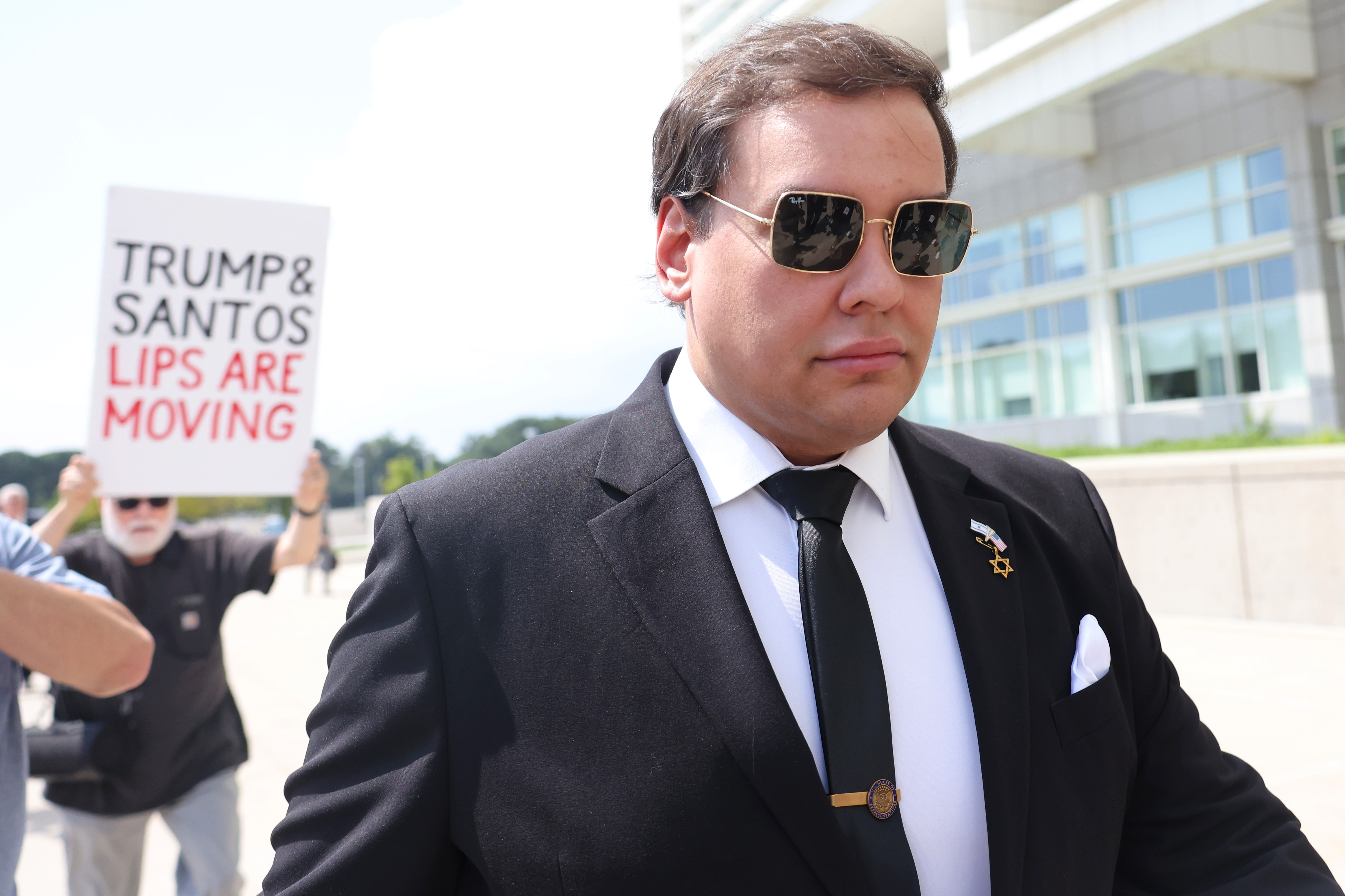 George Santos in a suit and sunglasses