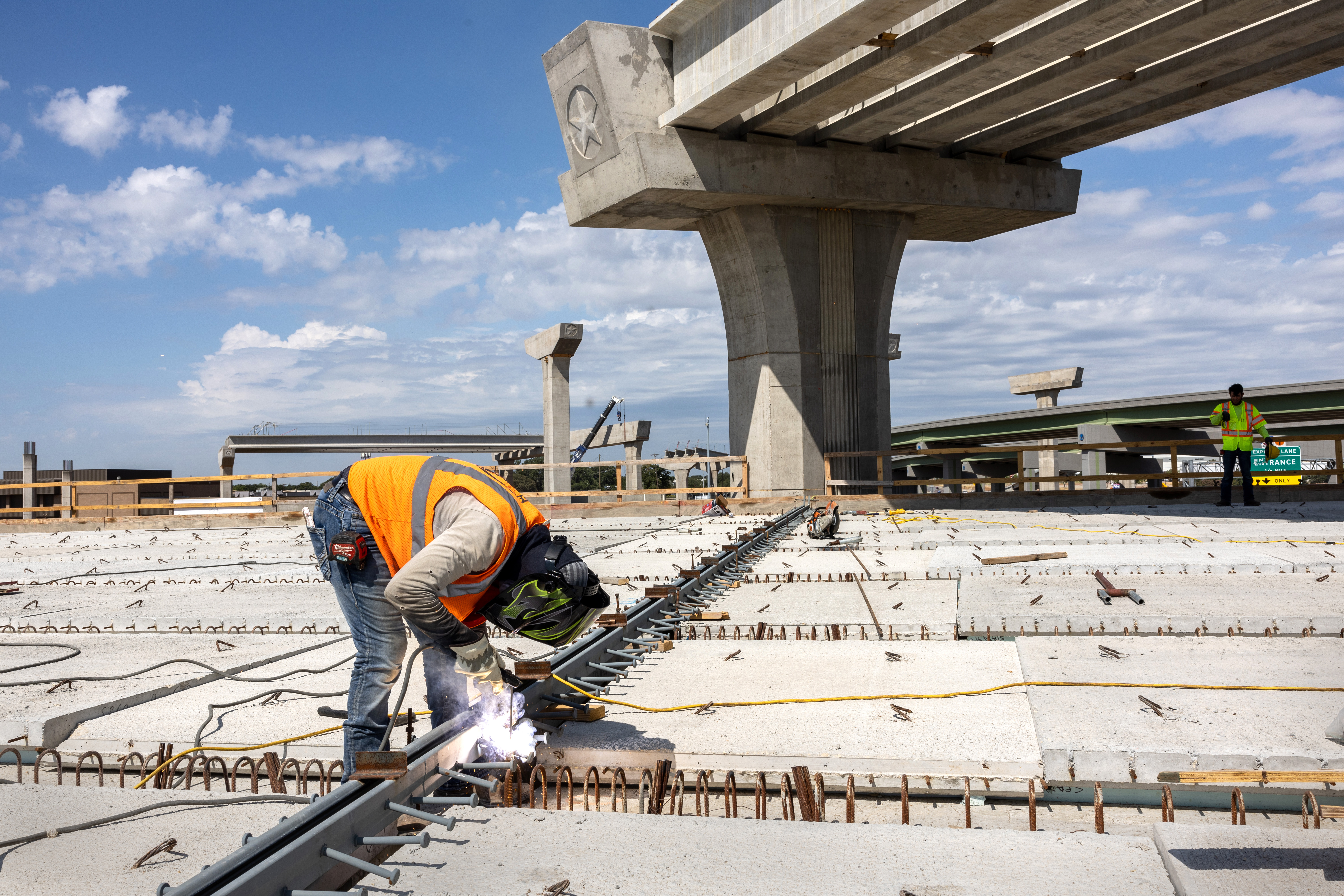 A construction worker welding rebar.