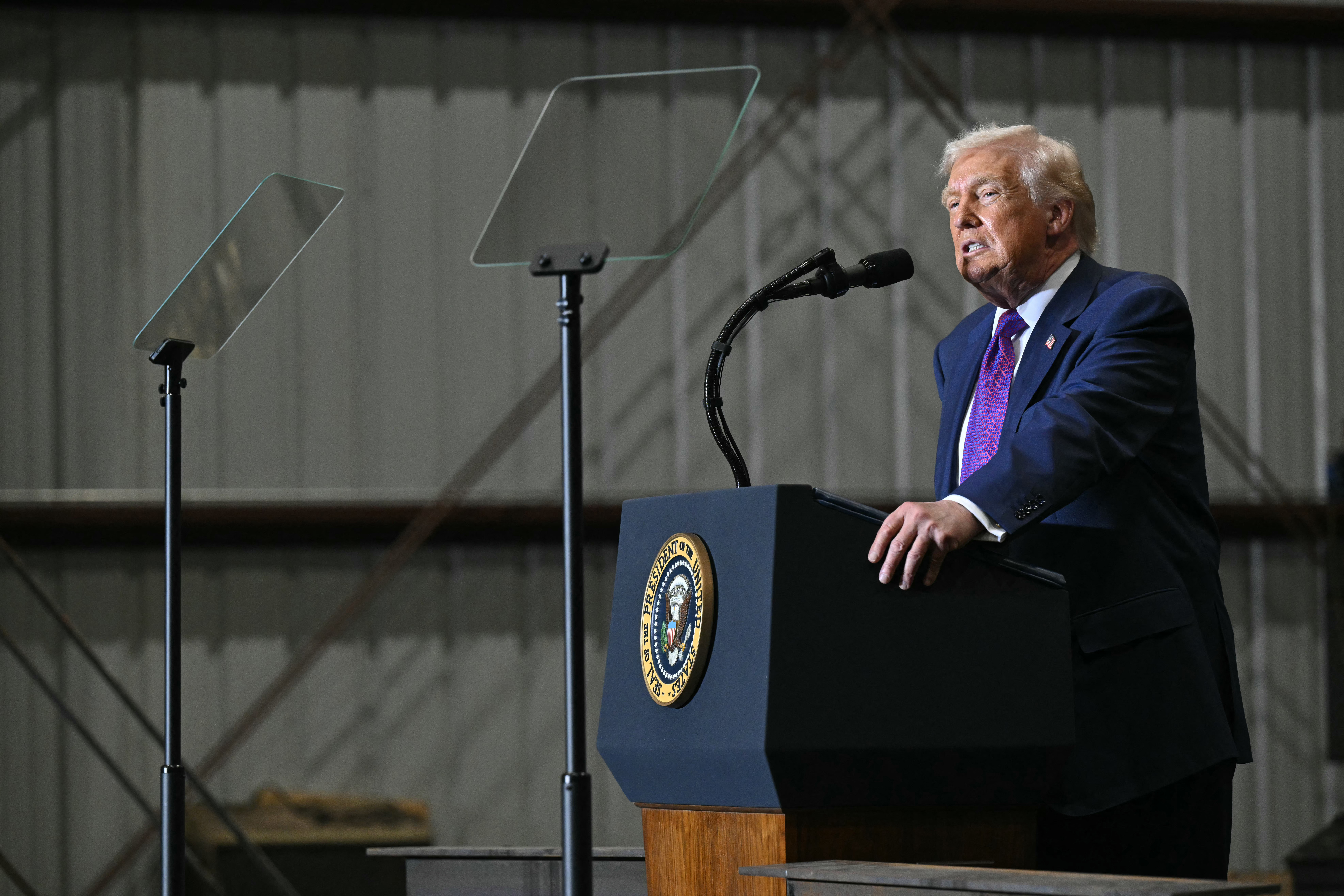 President Donald Trump speaks behind two teleprompters