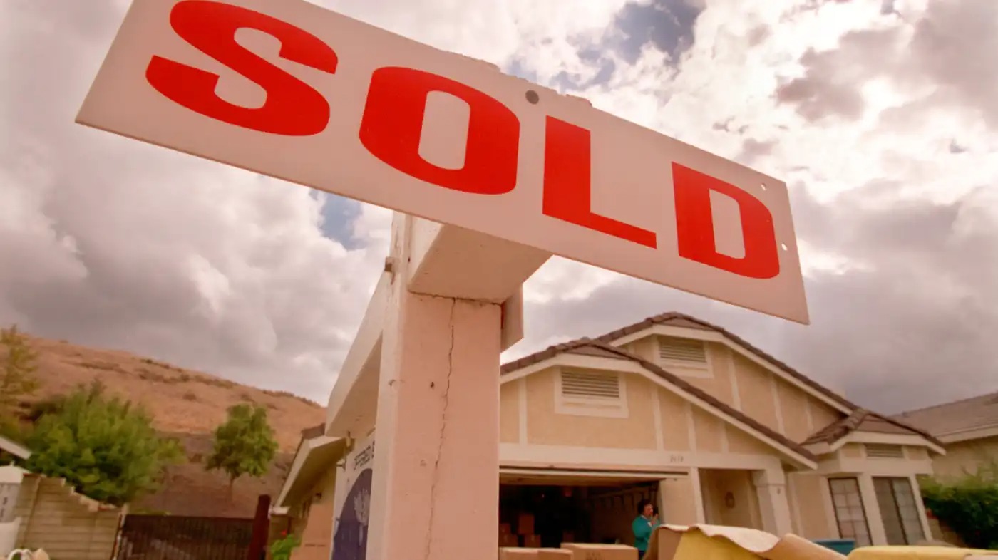A sold sign in front of a house