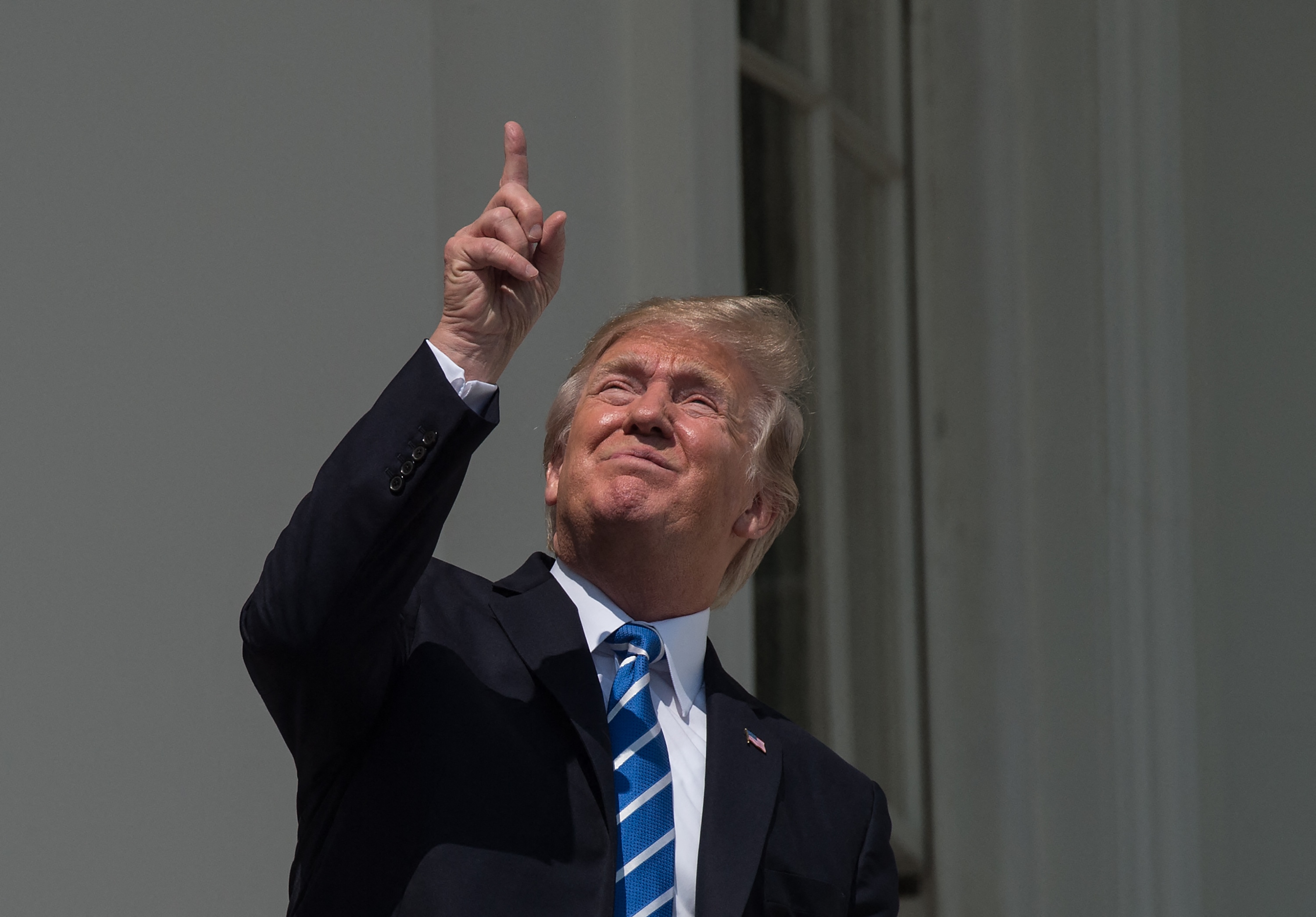 President Donald Trump looks directly into an ecclipse.