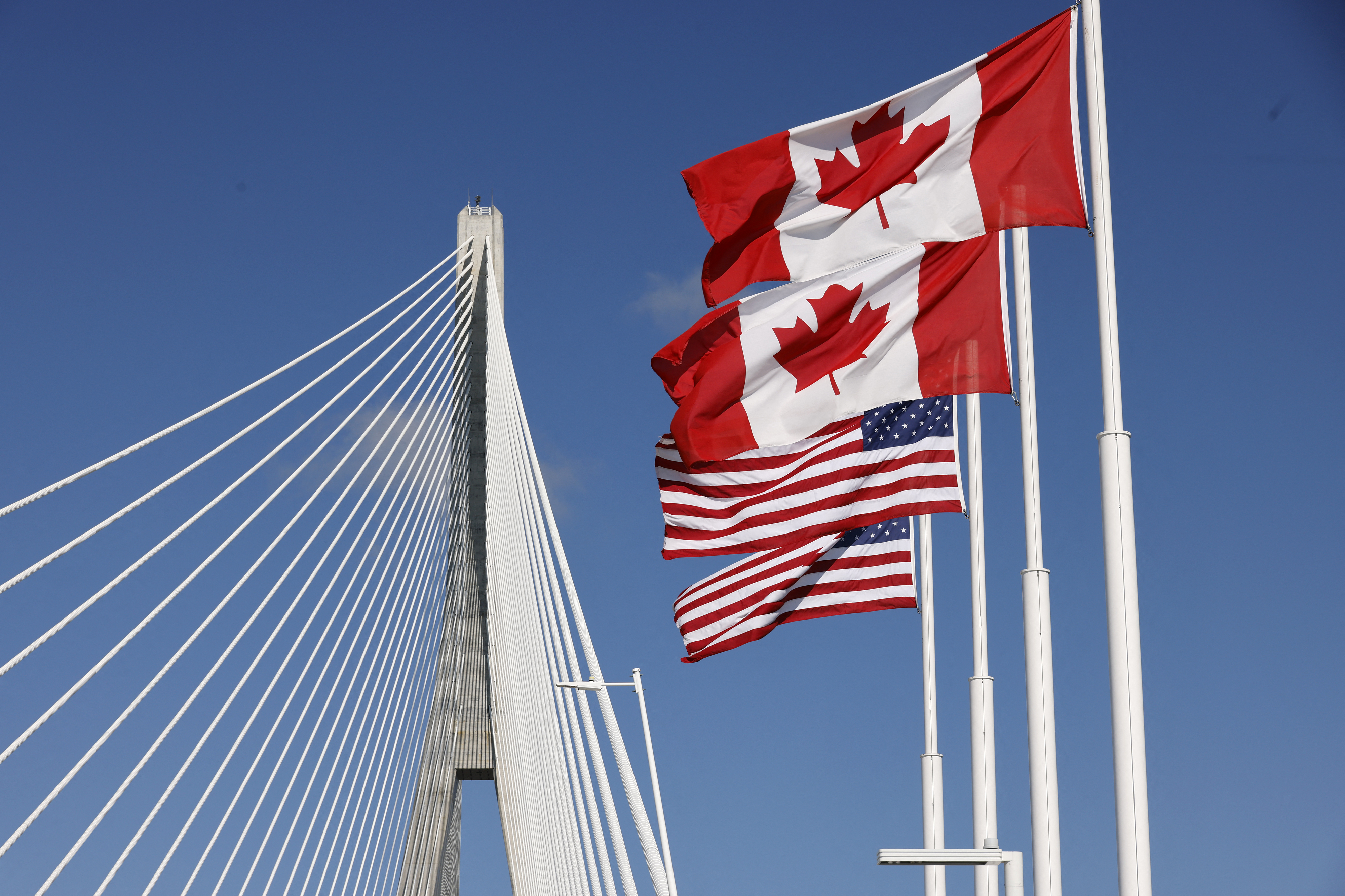Canadian and U.S. flags waving