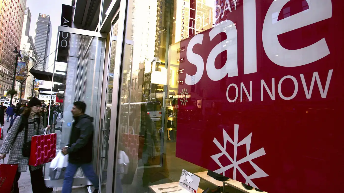 Shoppers bustling in out of stores during the holiday season.