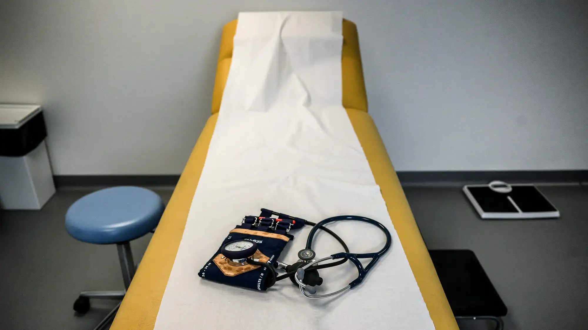 An empty exam table in a doctor's office.