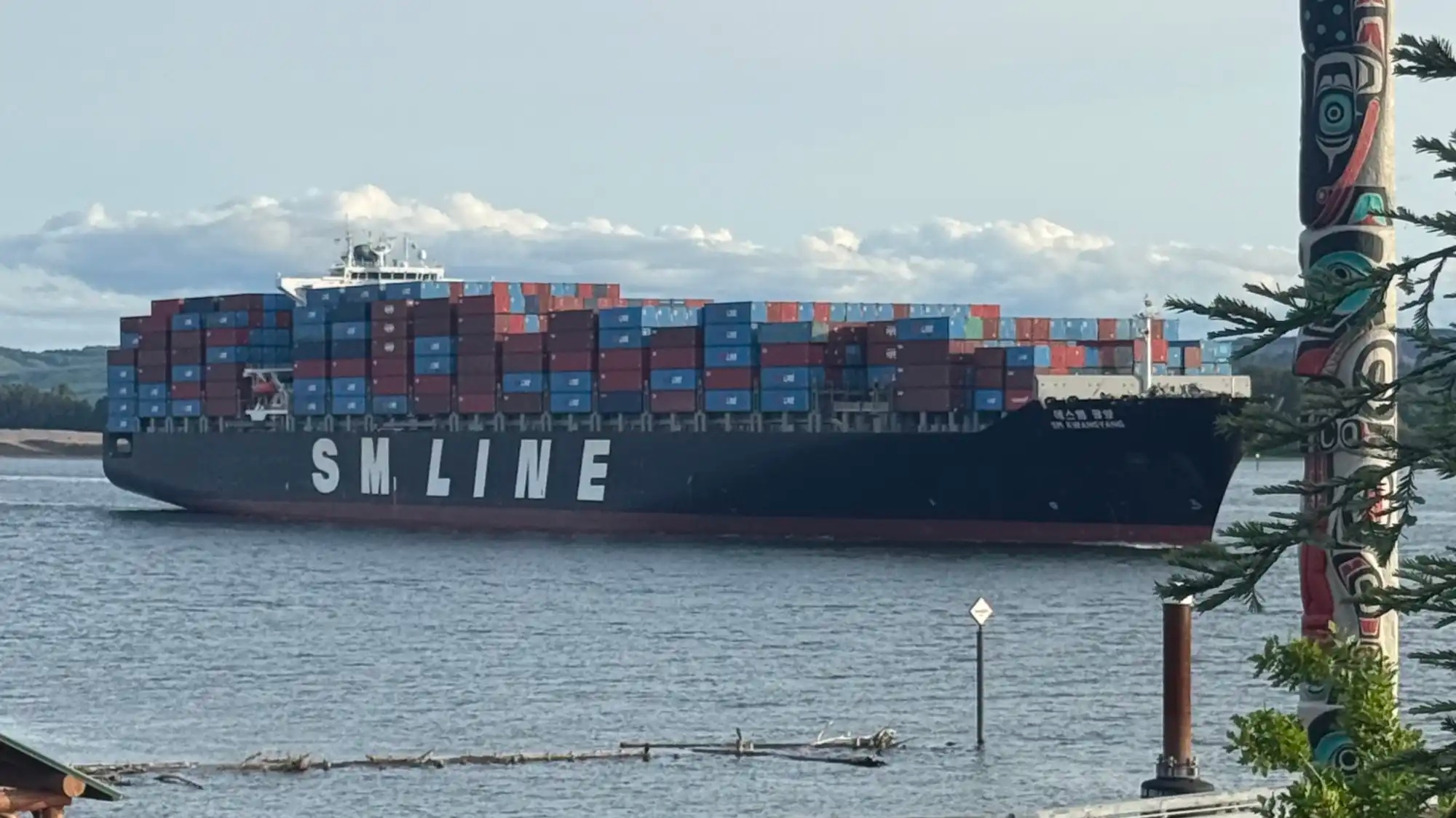 A ship laden with cargo containers on the Columbia River.