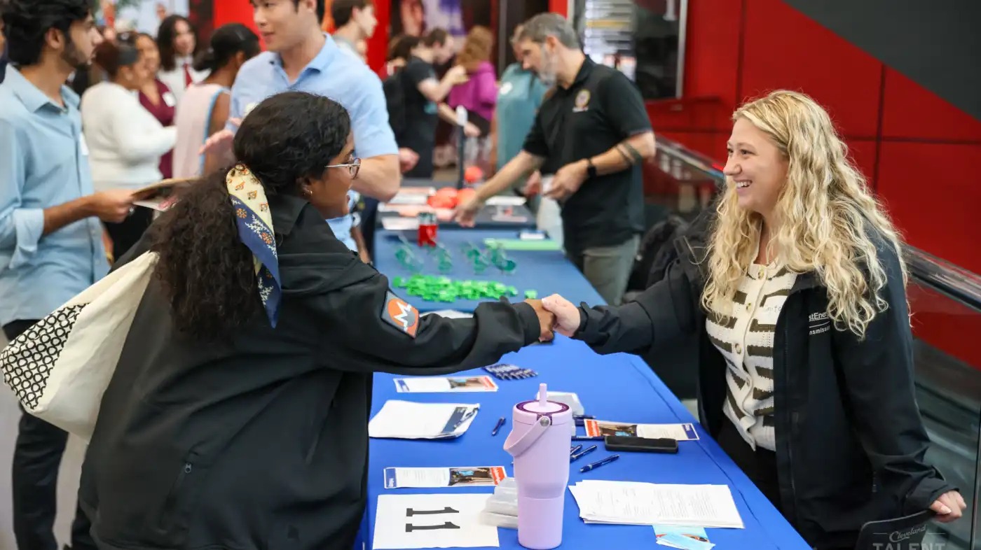 Dayton Gebeau (right) represented one of the 82 companies at CollegeFest, an annual career fair in Cleveland aimed at connecting students with potential employers.