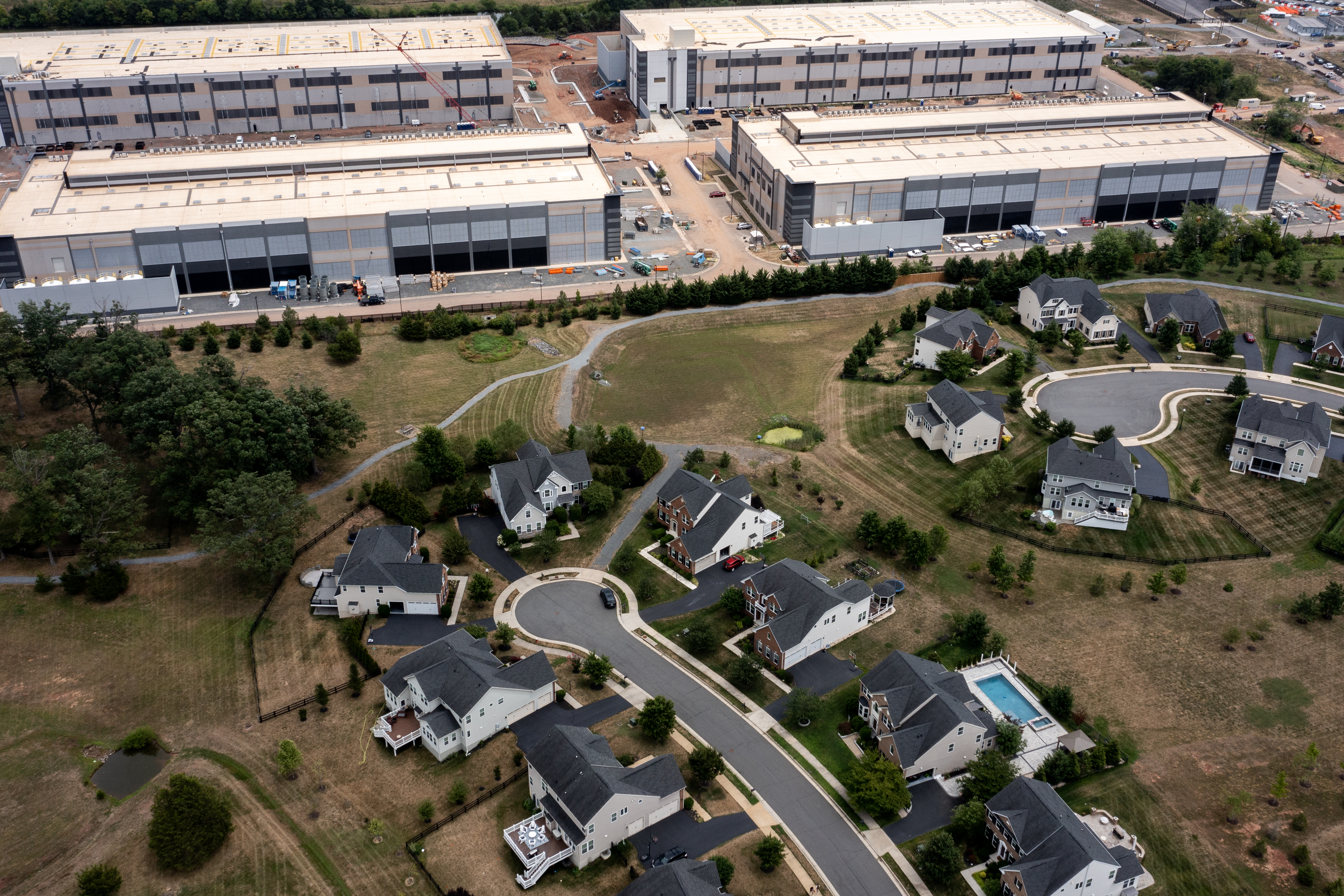 Seen from above: Several of suburban homes on a cul-de-sac back up to data centers.
