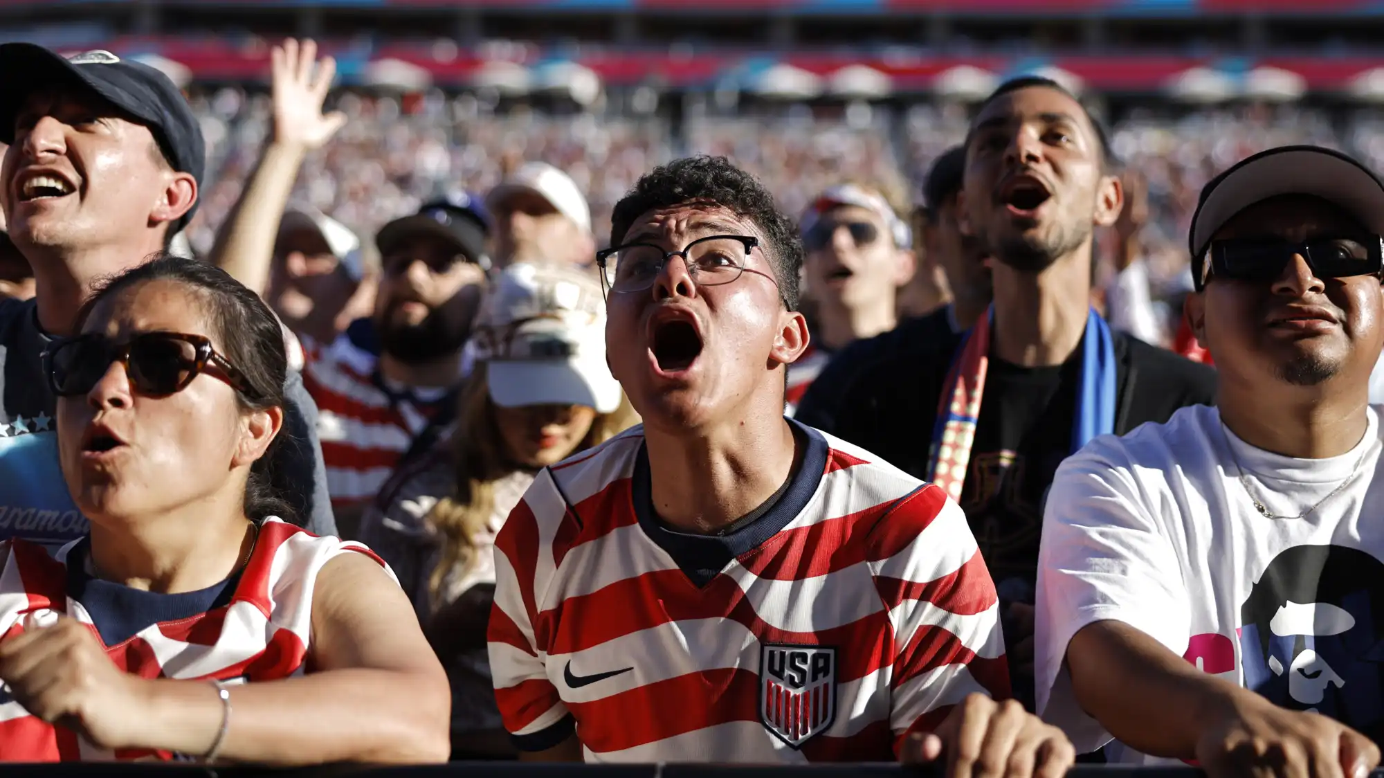 Fans shout in the crowd of a USA World Cup game.