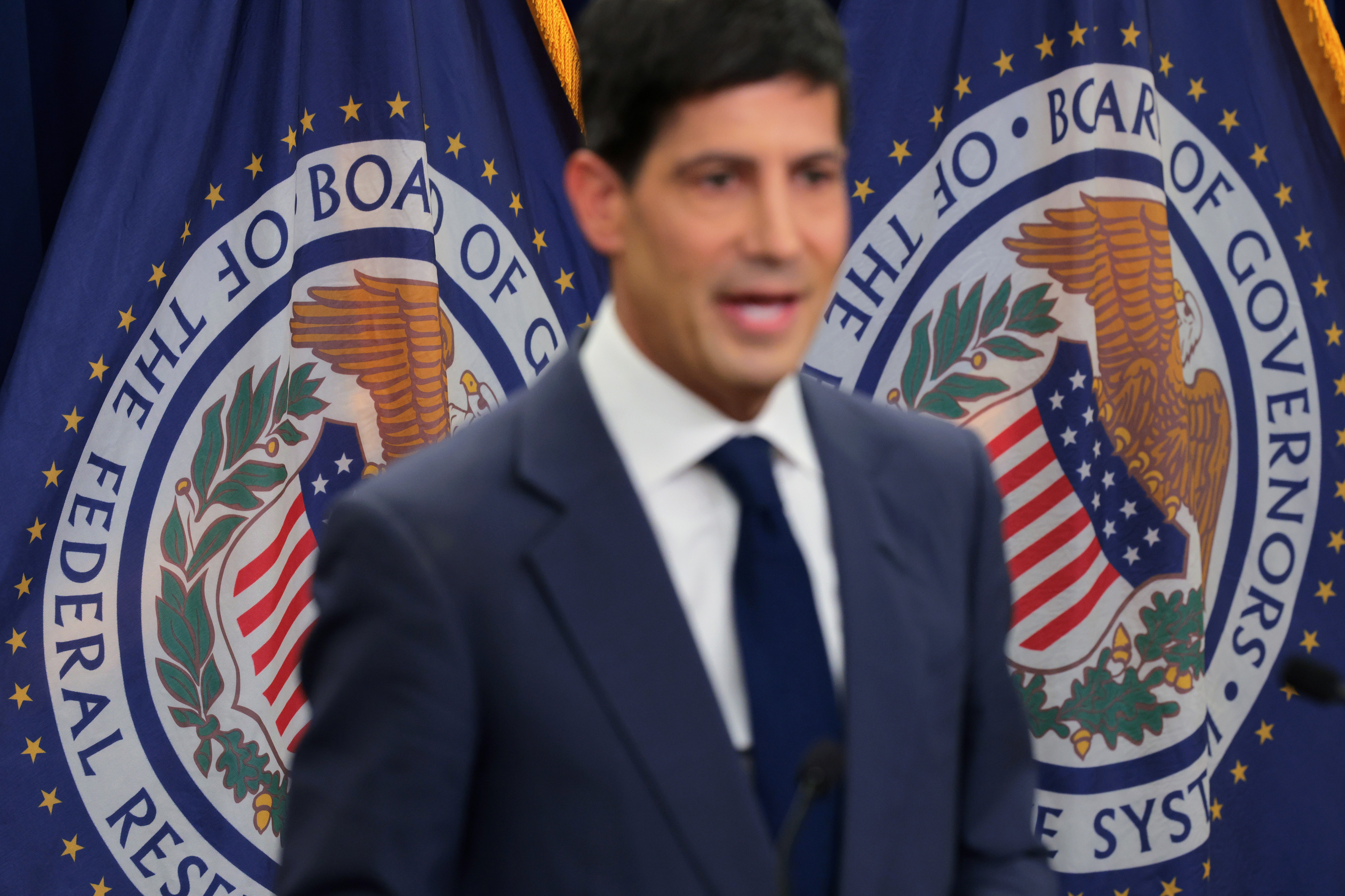 Fed Chair Kevin Warsh, out of focus.