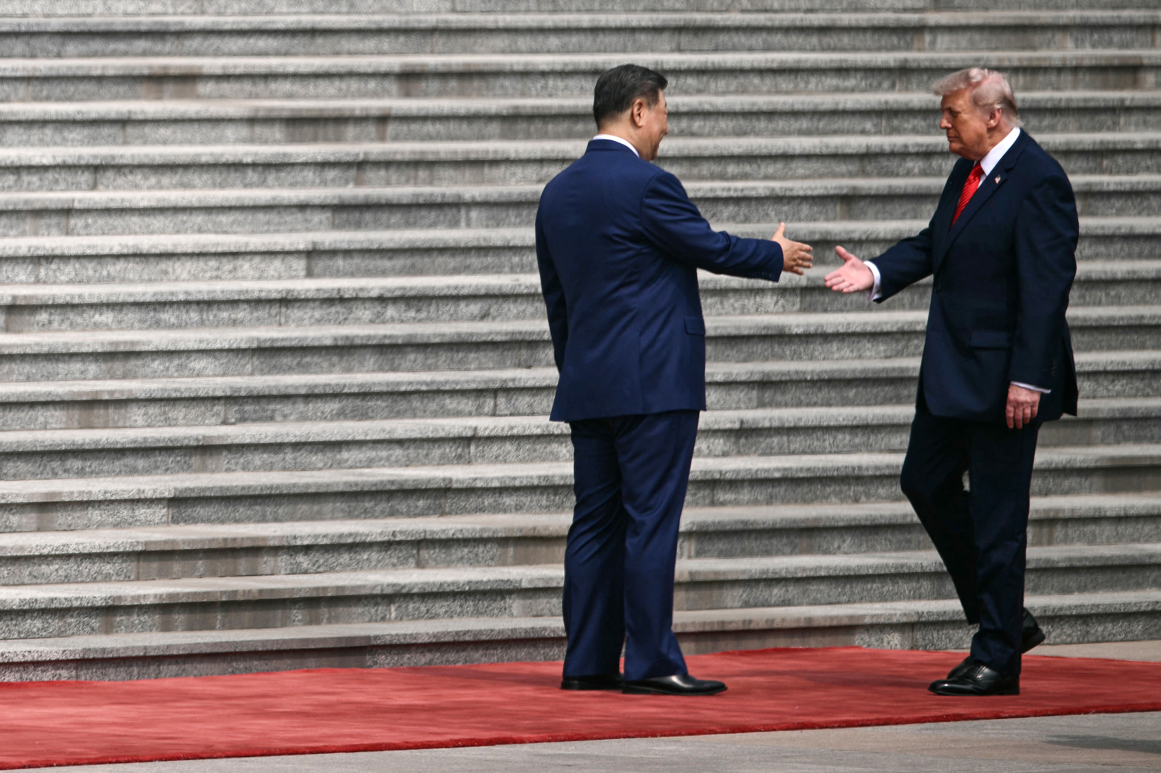 President Donald Trump shakes hands with Chinese President Xi Jinping.