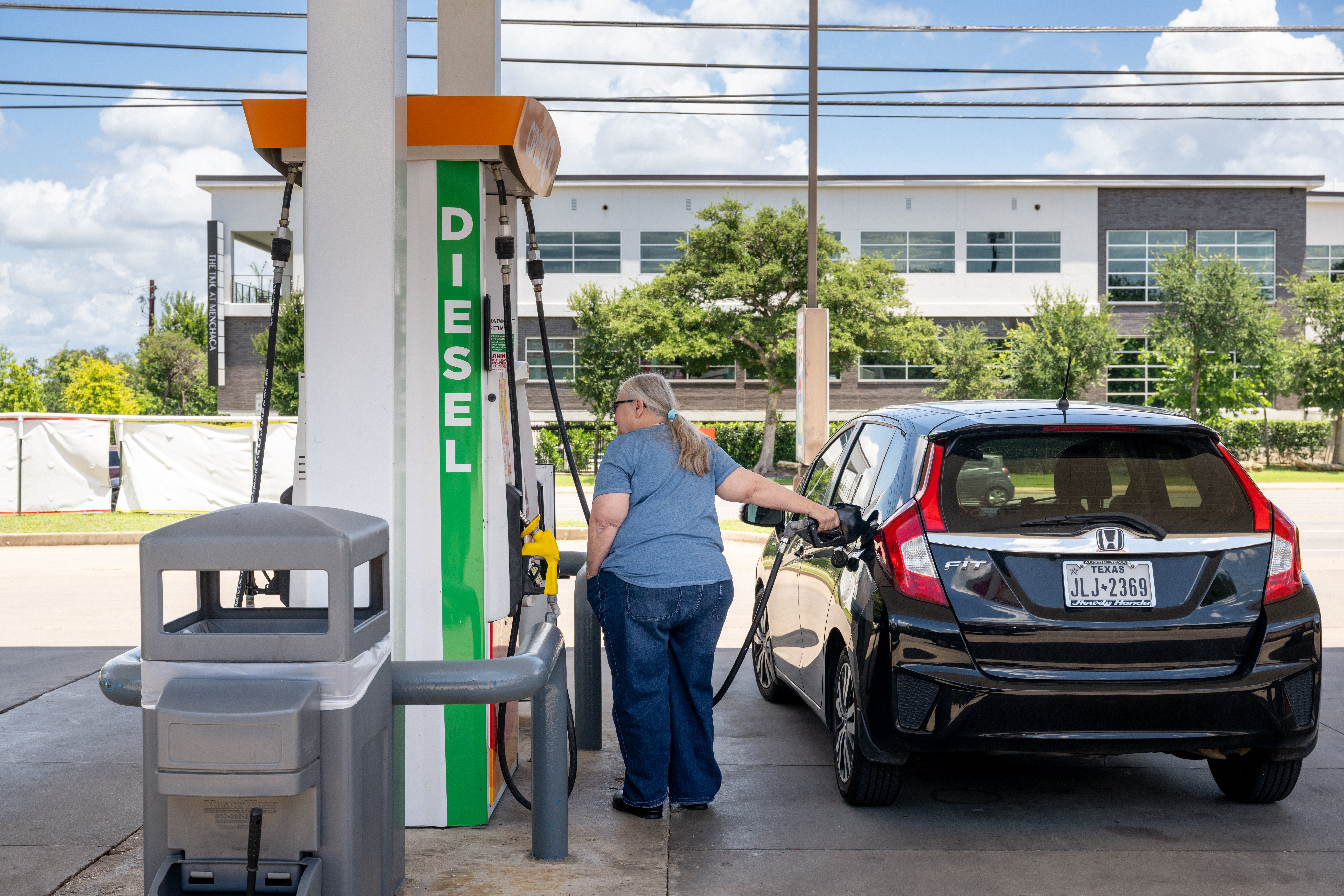A woman fills a gas tank in Texas.