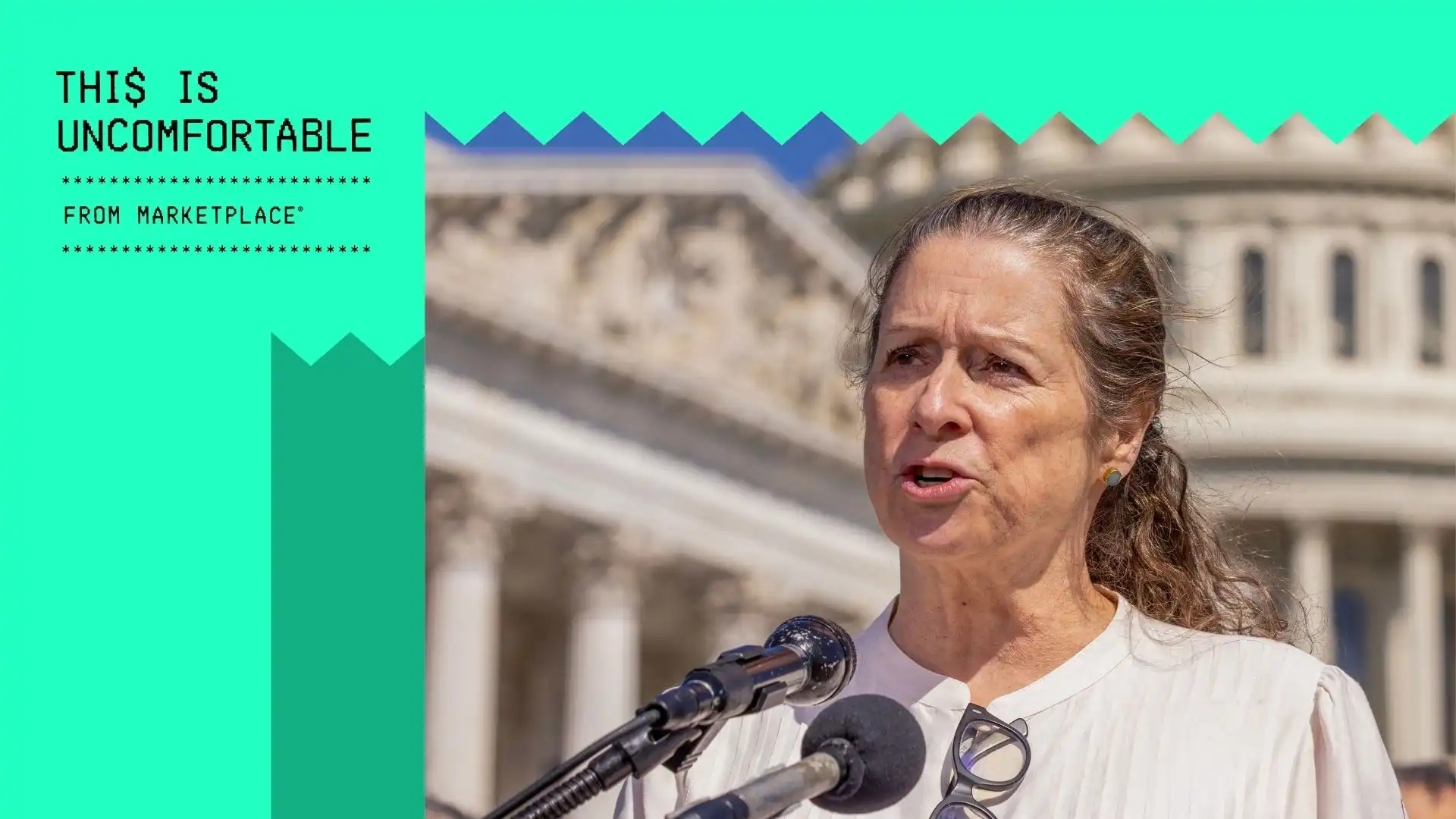 A woman speaks at a microphone next to the logo for Marketplace's podcast 