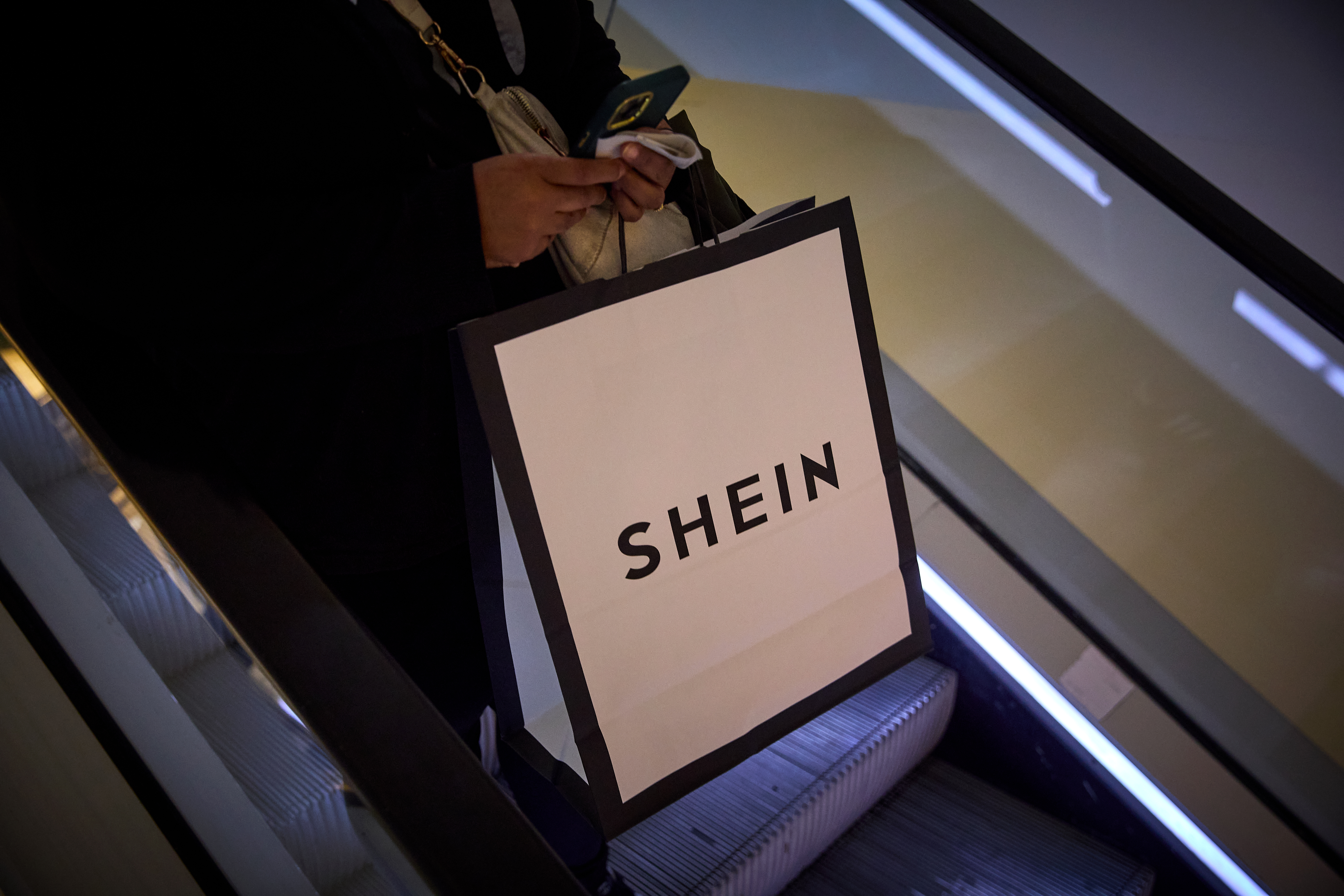 A shopper holds a Shein bag