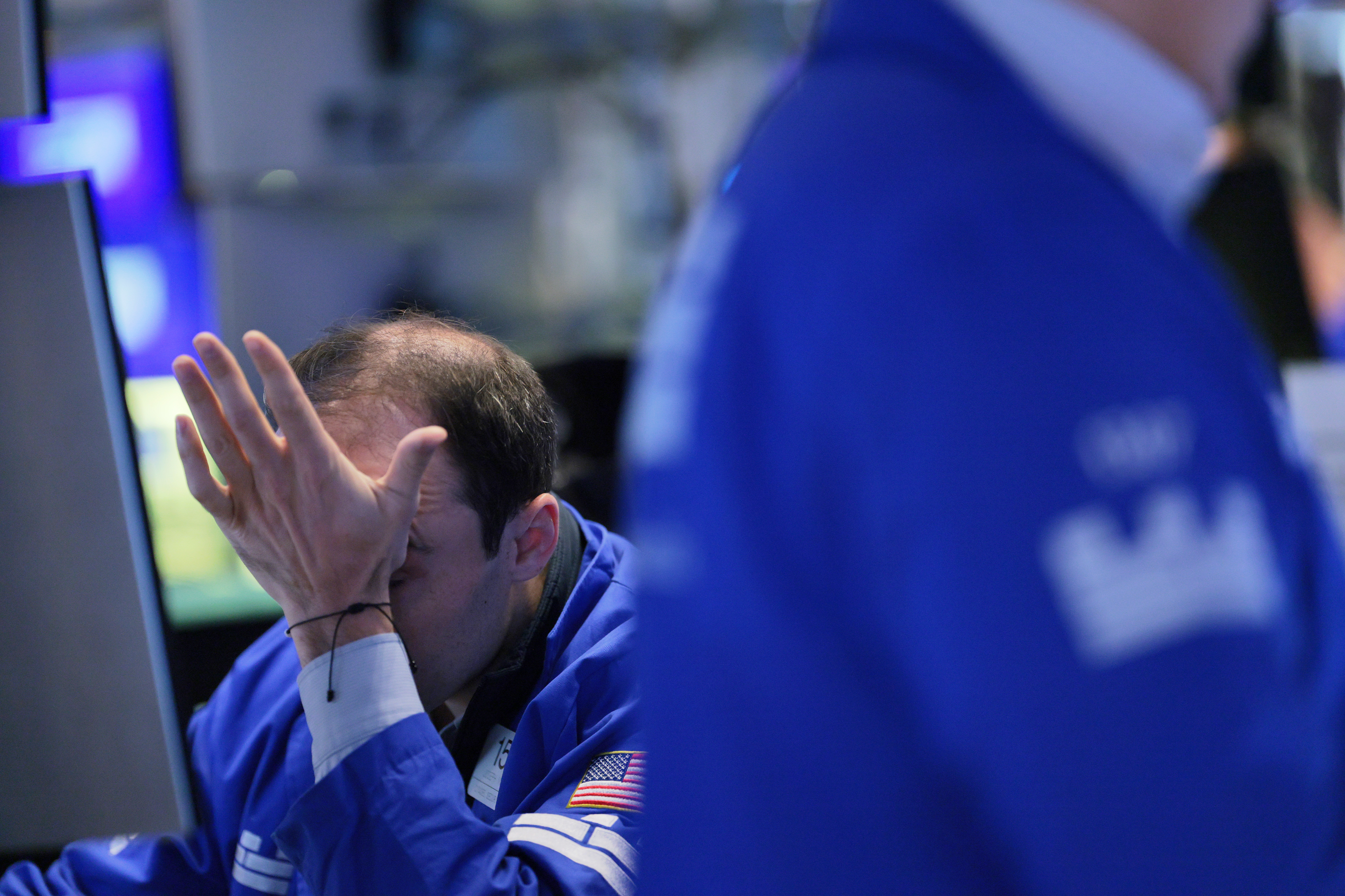 A stock trader slaps his forehead.