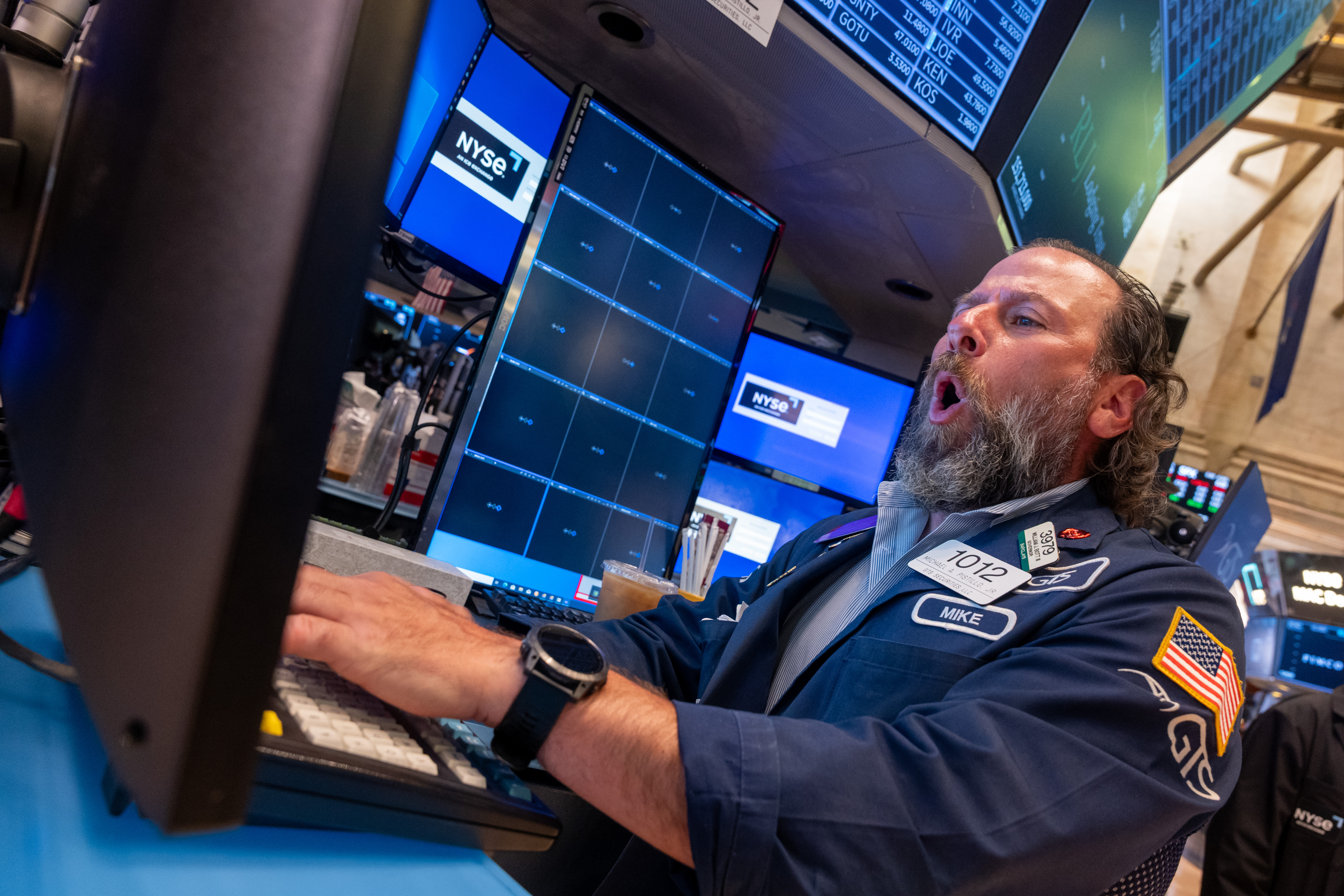 A trader looks excited while watching a monitor on the New York Stock Exchange.