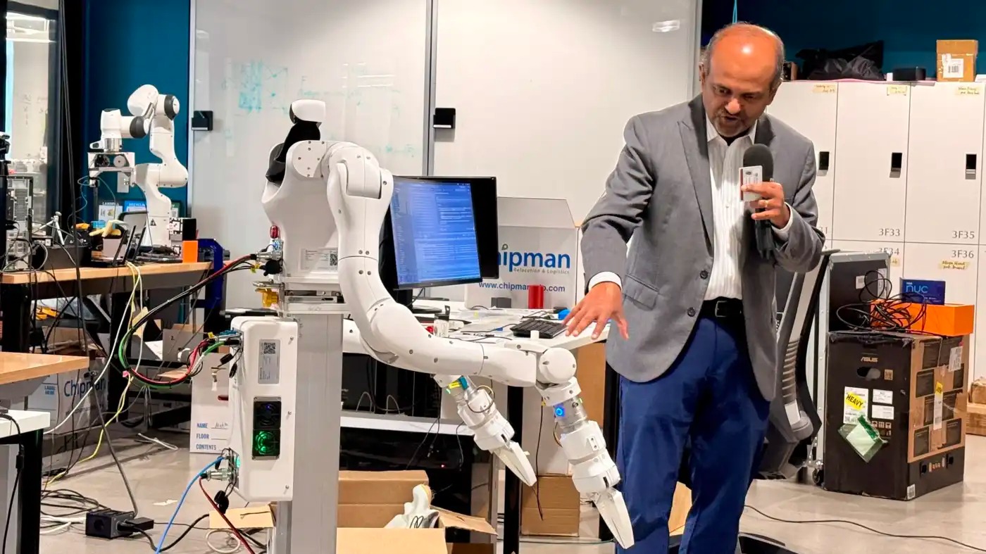 A man shows off a robotic arm