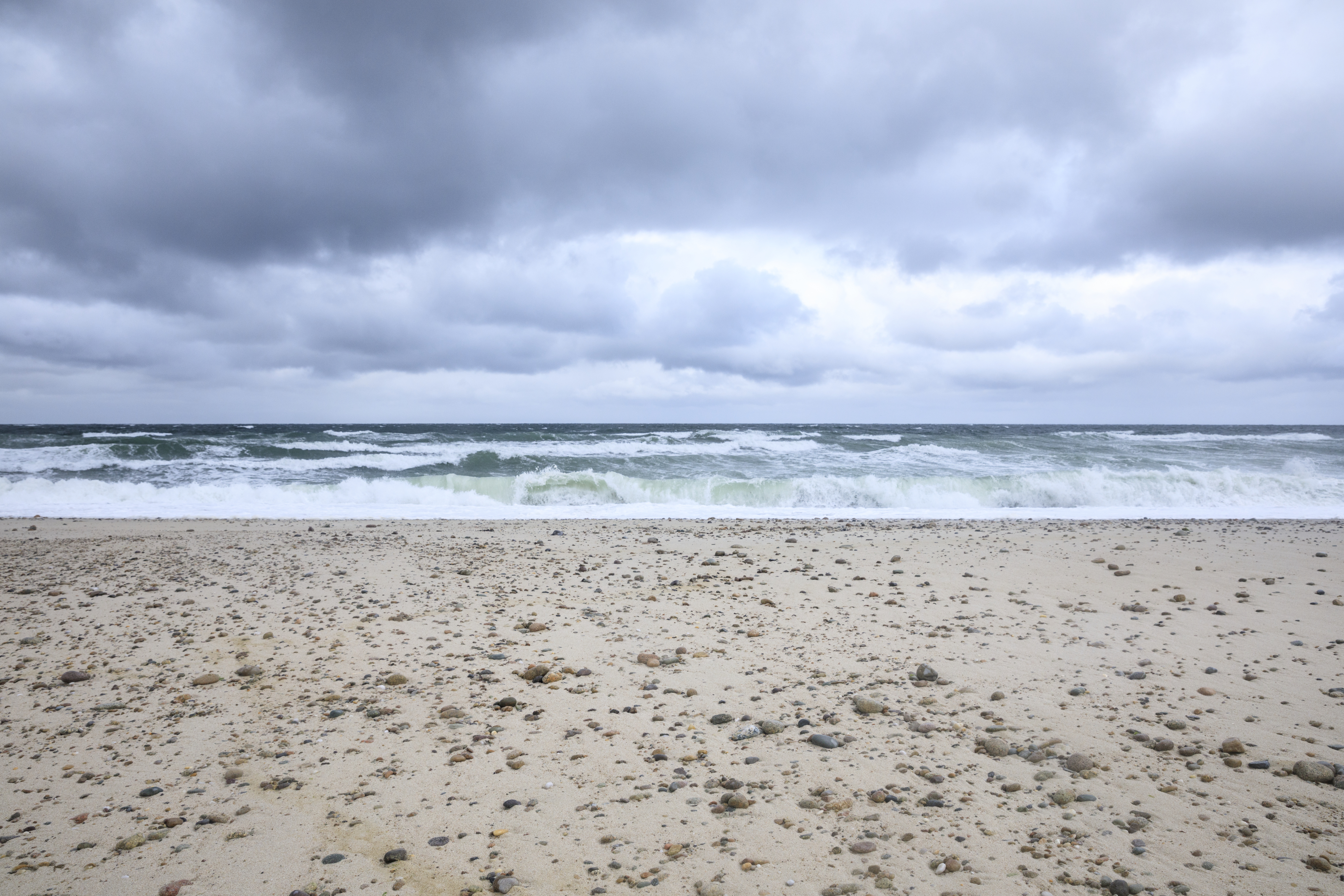 Storm clouds over an empty beach.