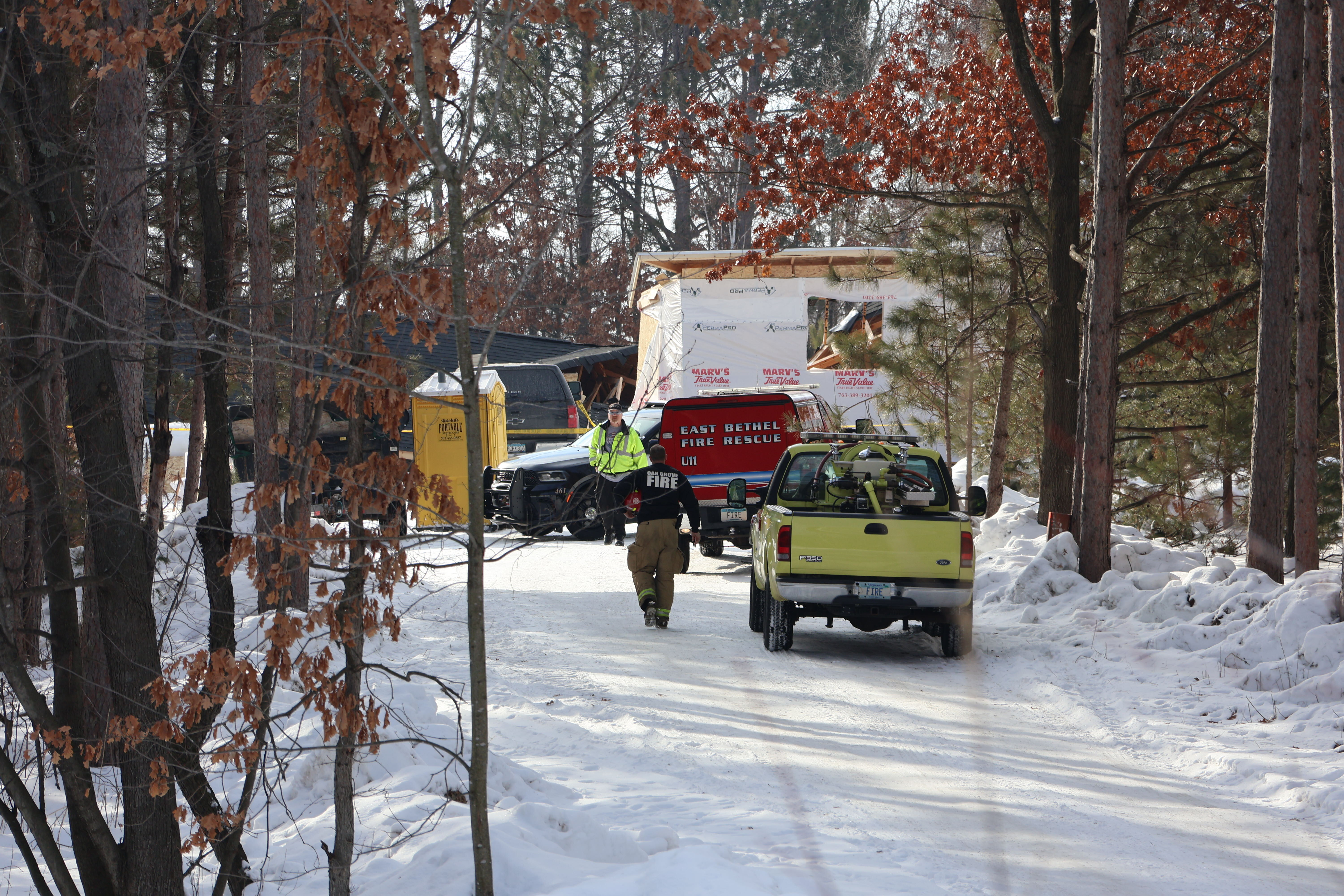 police officers and firefighters next to their vehicles 