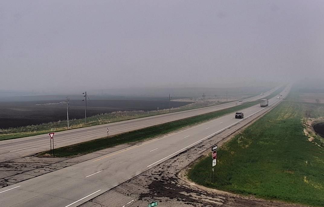 Thick haze is visible along a highway